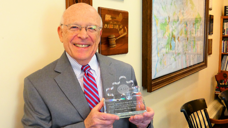 CAST Board Chair, Dr. Shelley Berman, holding his 2020 Utne O’Brien Award for Excellence