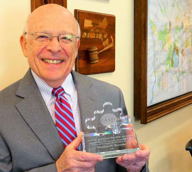 CAST Board Chair, Dr. Shelley Berman, holding his 2020 Utne O’Brien Award for Excellence