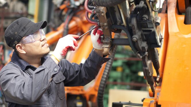 Worker fixing an engine