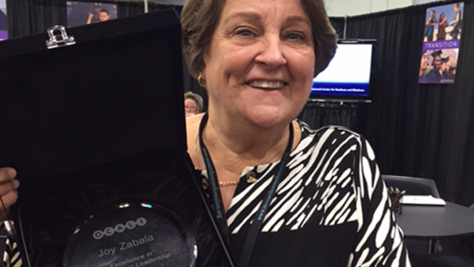 Photo of Joy Zabala holding her OCALI award