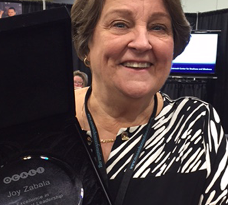 Photo of Joy Zabala holding her OCALI award