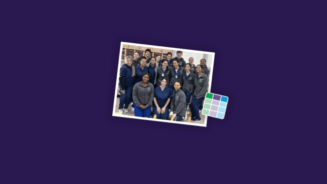 Group of 21 young adults smiling and posing in rows for the camera while wearing matching blue and gray scrubs